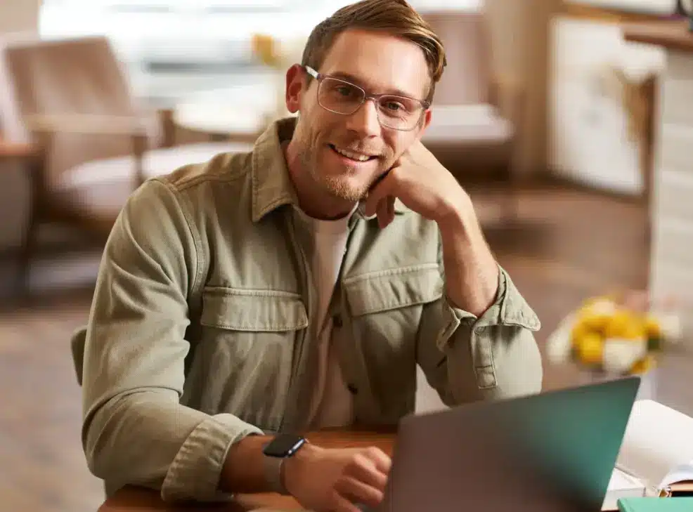 a-man-engaged-in-an-online-therapy-session-writing-down-thoughts-in-his-notebook-during-a-remote-counselling-appointment